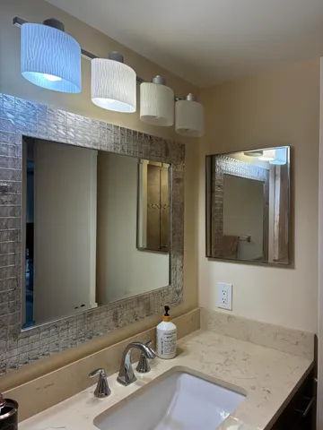 a bathroom with a sink and a mirror