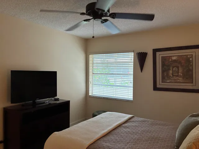 a bedroom with a bed and a flat screen tv
