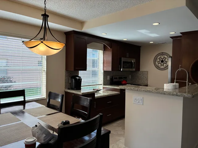 a kitchen with a sink cabinets and window