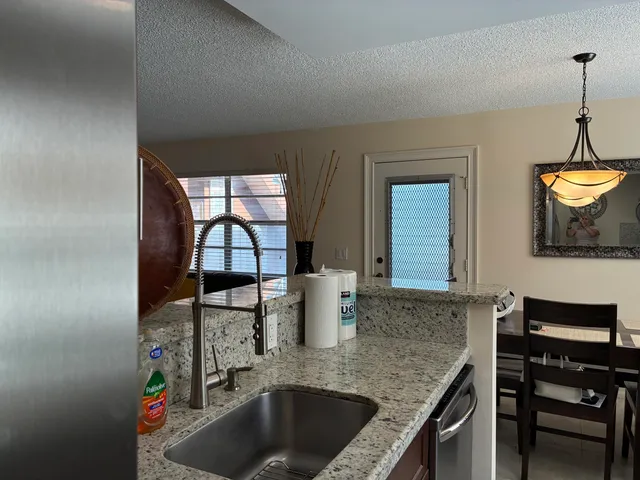 a kitchen with a sink a stove and a window