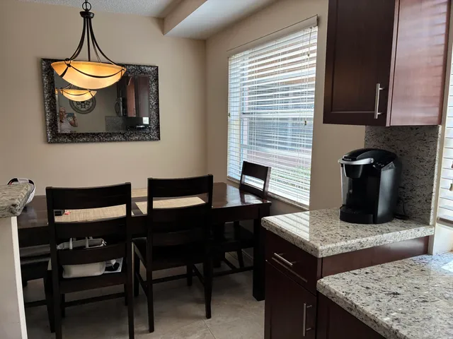 a kitchen with a table and chairs in it