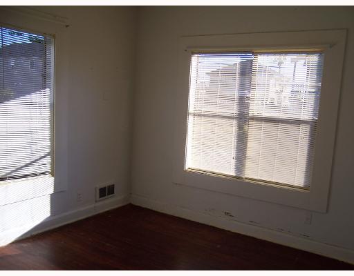 1224 2nd Street Corpus Christi, TX 78404 - Photo 7 of 8 a view of an empty room with wooden floor and a window