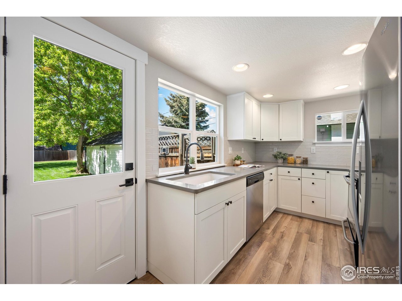 217 Locust Street Windsor, CO 80550 - Photo 12 of 40 a kitchen with a stove a sink a refrigerator and a oven