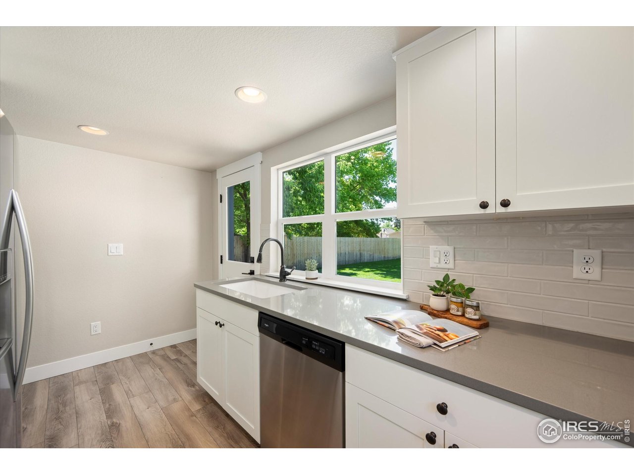 217 Locust Street Windsor, CO 80550 - Photo 13 of 40 a kitchen with a sink cabinets and window