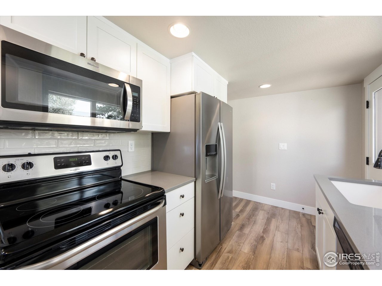 217 Locust Street Windsor, CO 80550 - Photo 15 of 40 a kitchen with a stove microwave and refrigerator