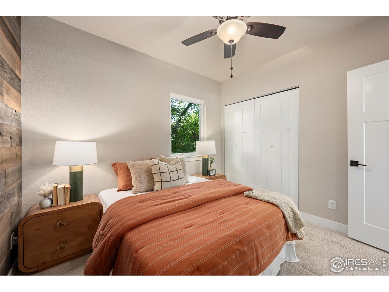 217 Locust Street Windsor, CO 80550 - Photo 17 of 40 a bedroom with a large bed and a chandelier