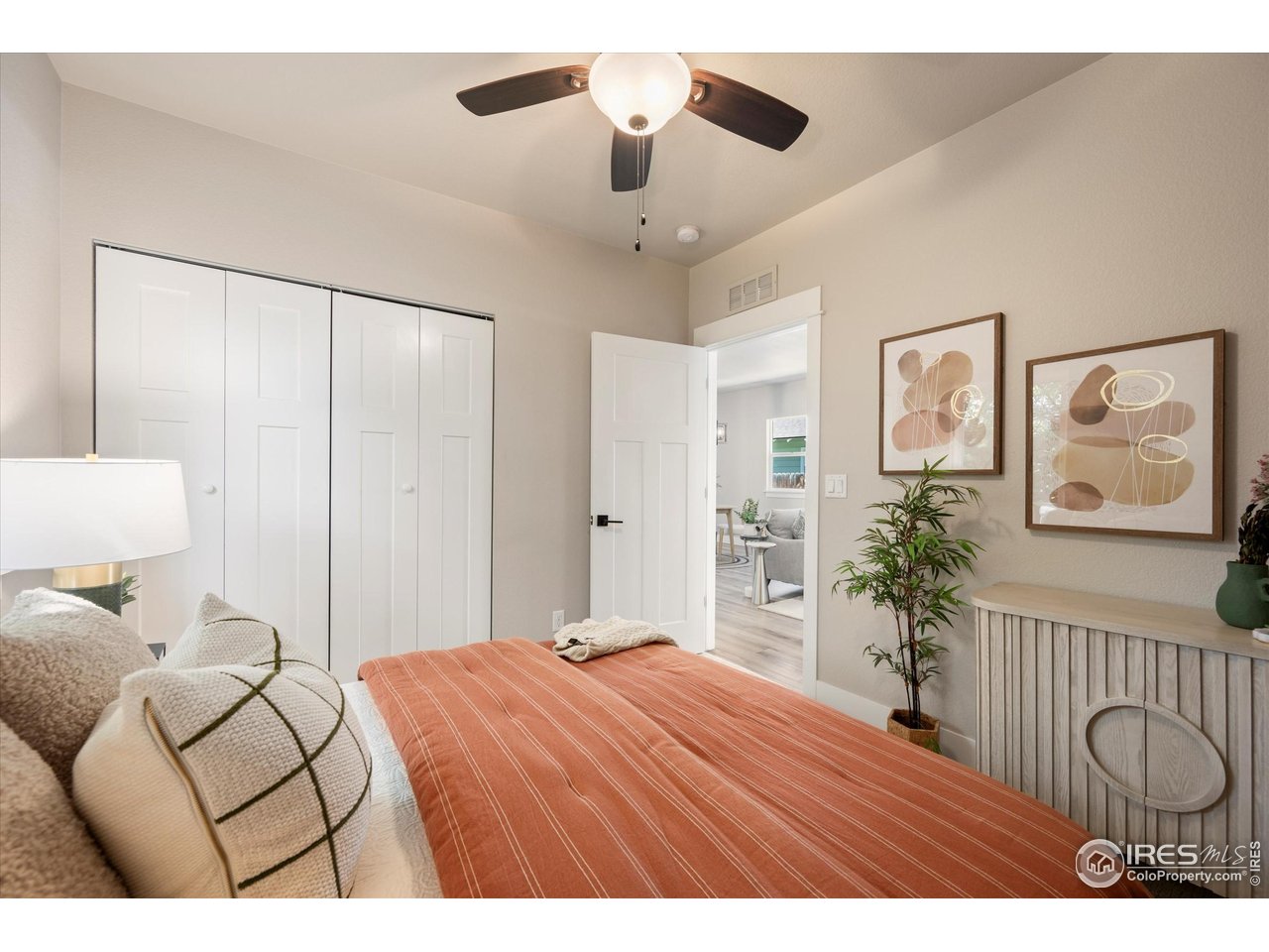217 Locust Street Windsor, CO 80550 - Photo 19 of 40 a bedroom with a bed and a chandelier