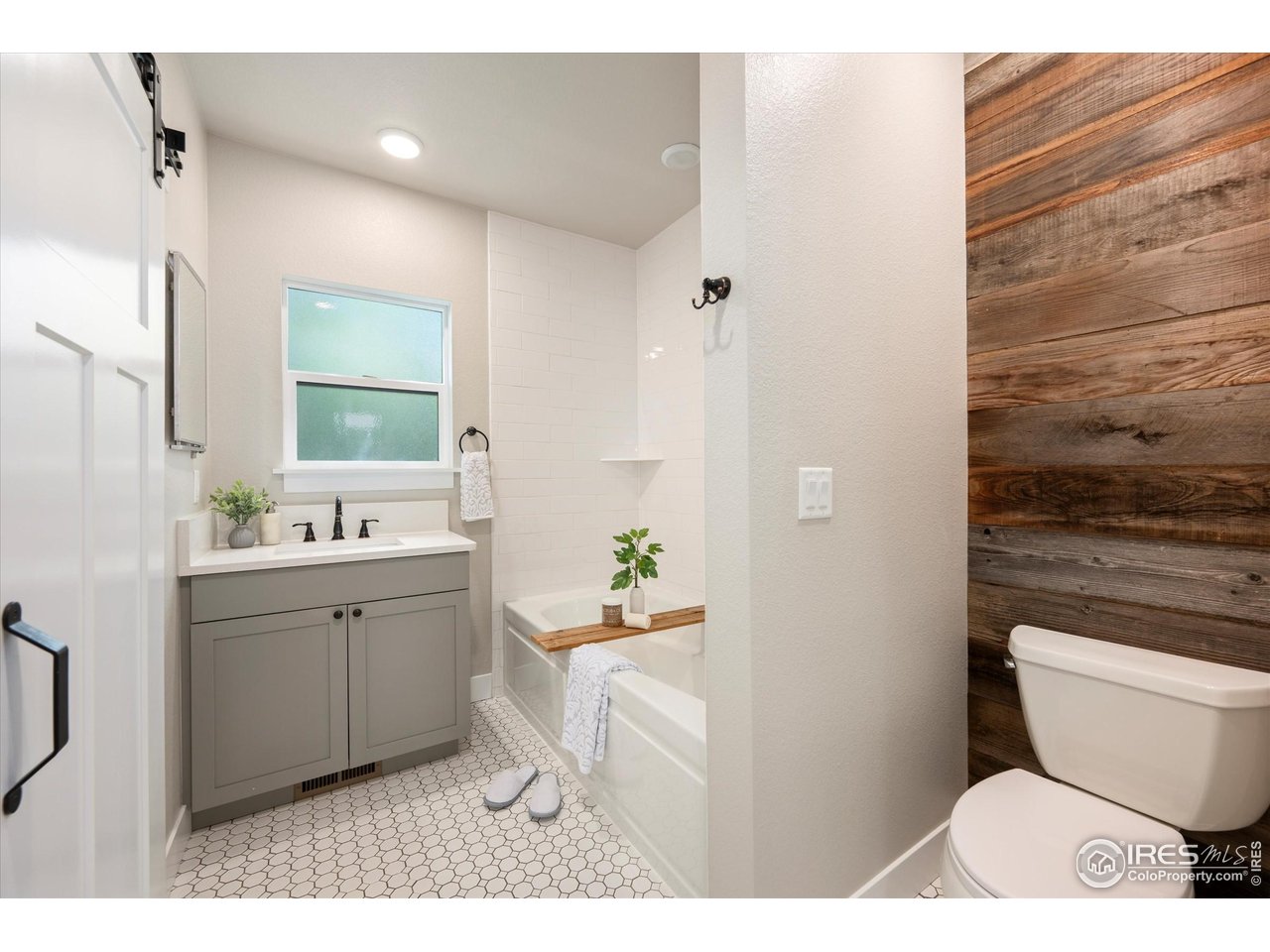 217 Locust Street Windsor, CO 80550 - Photo 20 of 40 a bathroom with a toilet a sink and mirror