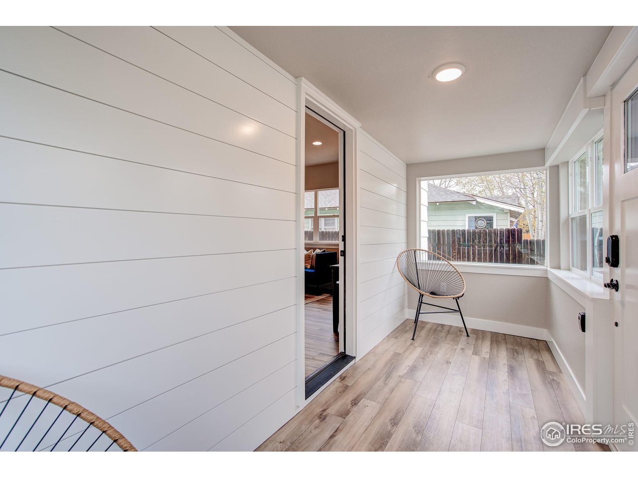 217 Locust Street Windsor, CO 80550 - Photo 2 of 40 a living room with furniture and a wooden floor