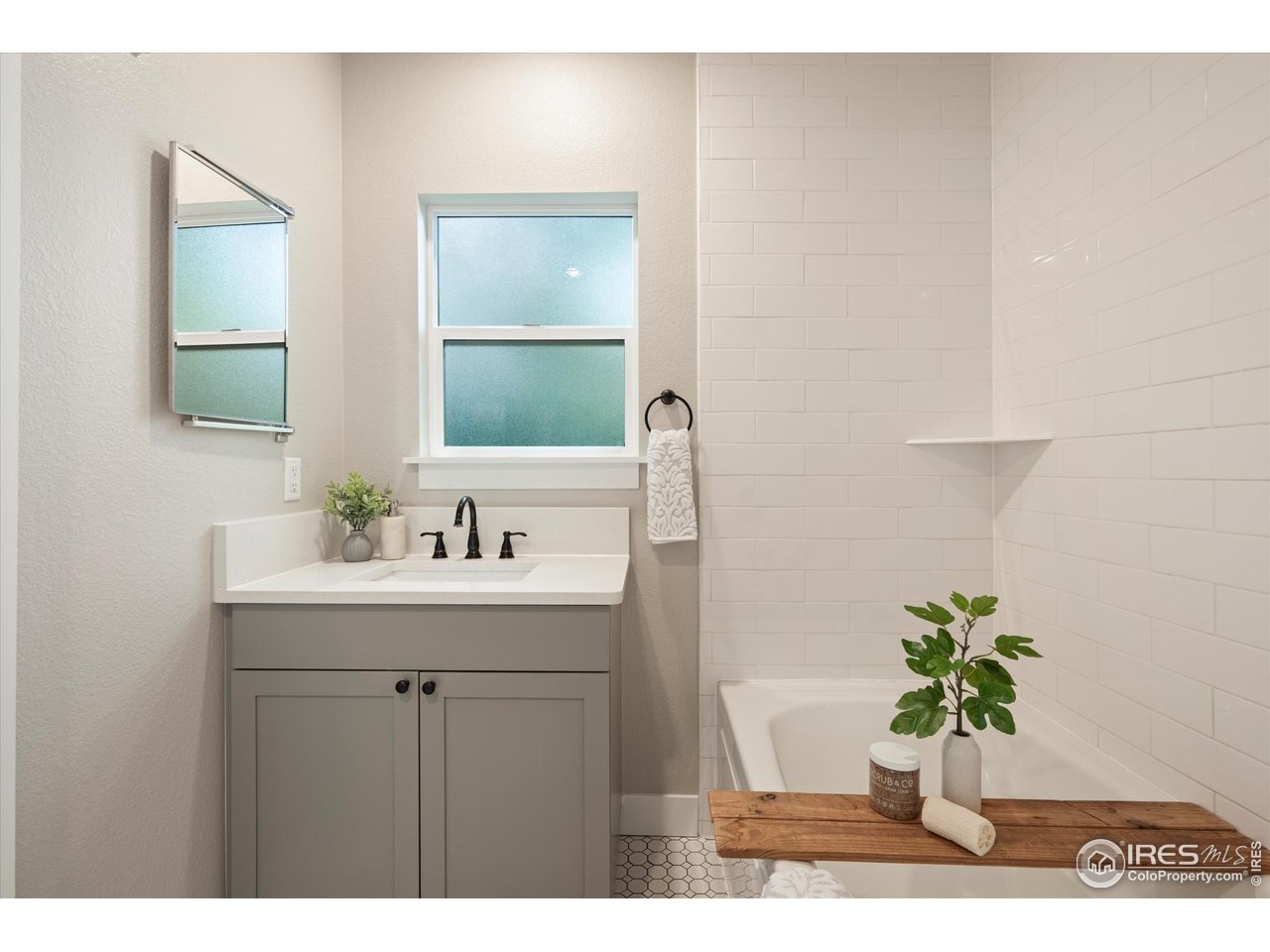 217 Locust Street Windsor, CO 80550 - Photo 22 of 40 a view of bathroom with a sink and a mirror