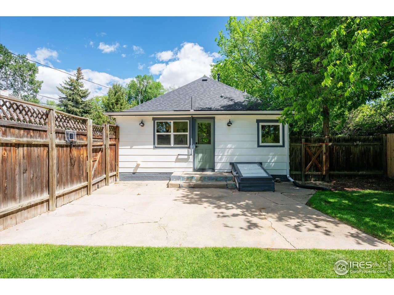 217 Locust Street Windsor, CO 80550 - Photo 32 of 40 a backyard of a house with yard and outdoor seating