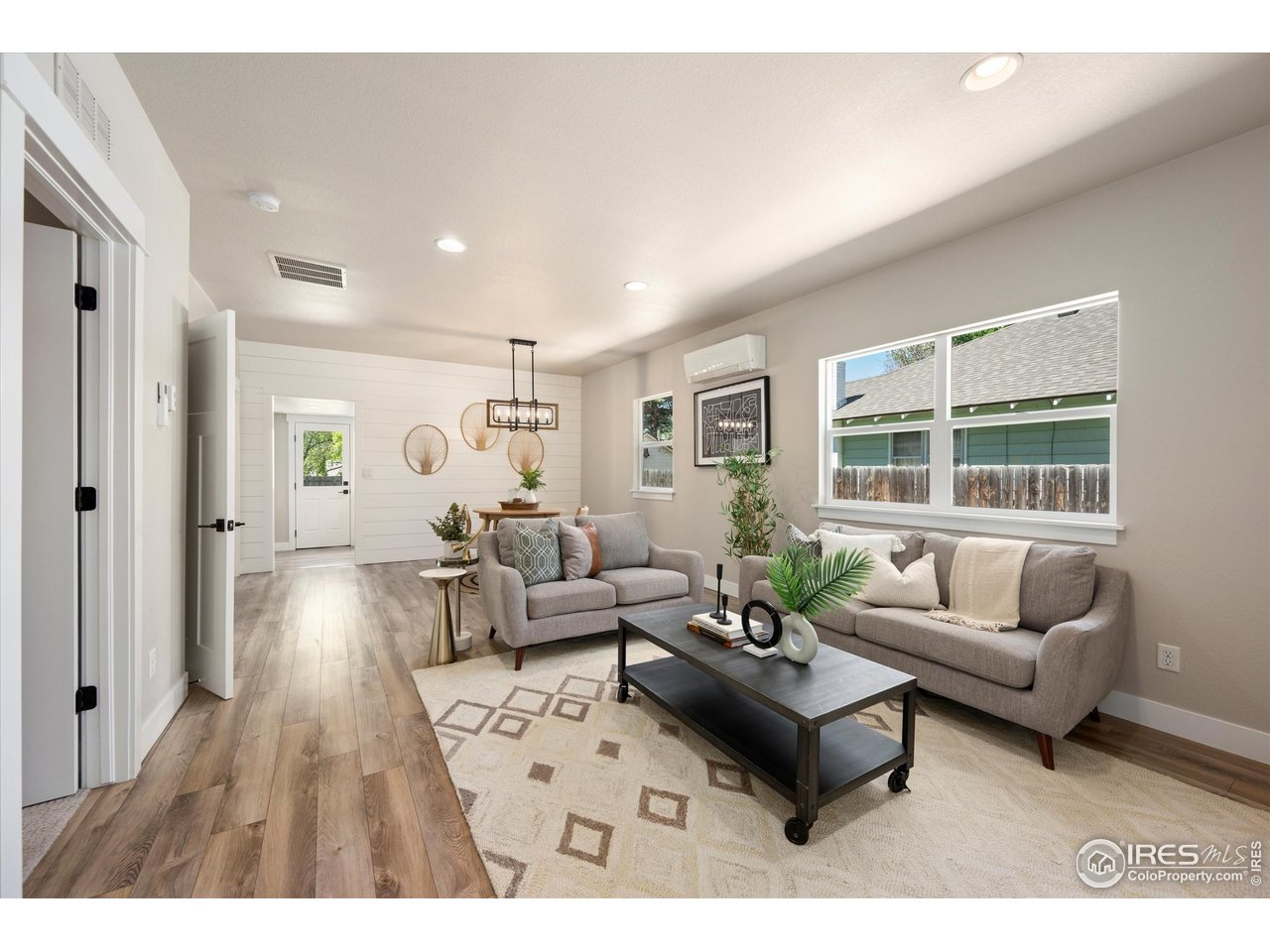 217 Locust Street Windsor, CO 80550 - Photo 5 of 40 a living room with furniture and a large window