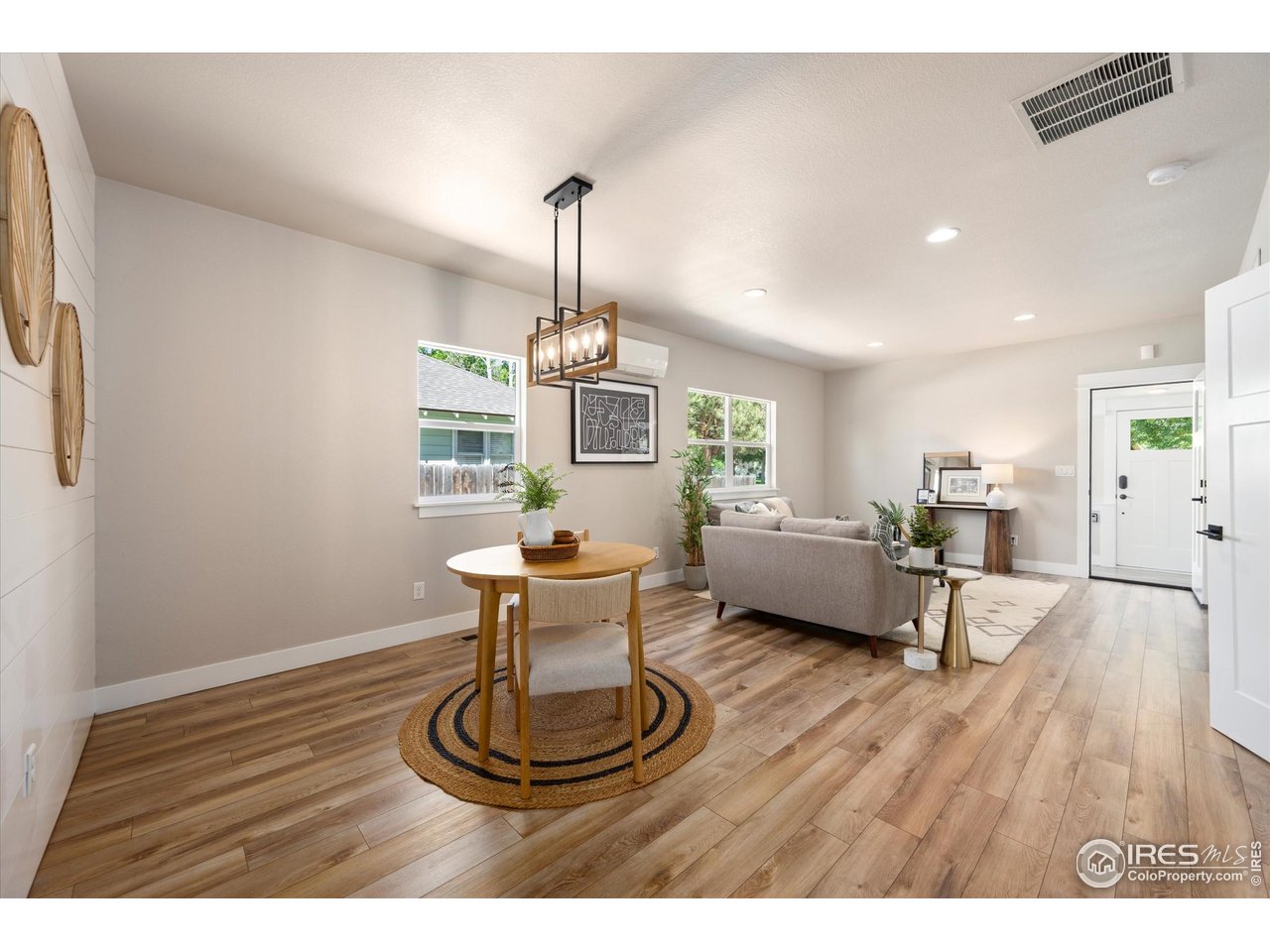 217 Locust Street Windsor, CO 80550 - Photo 7 of 40 a living room with furniture and a wooden floor