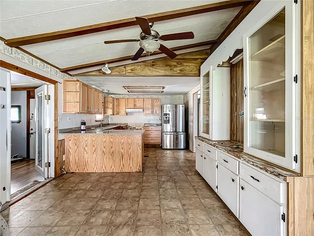a view of kitchen with granite countertop lots of counter top space