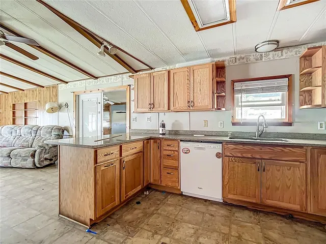 a kitchen with stainless steel appliances granite countertop a sink and cabinets