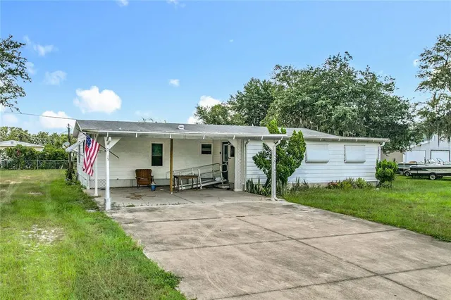 a view of a house with backyard porch and sitting area