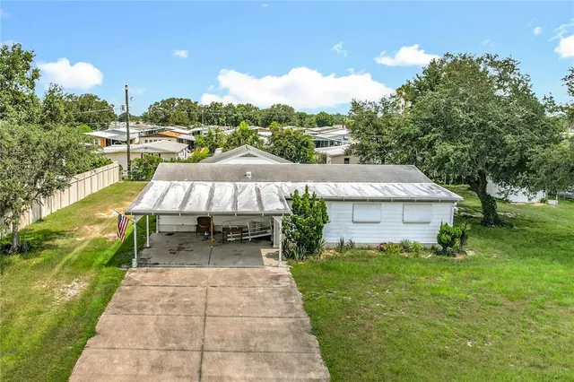 a backyard of a house with table and chairs
