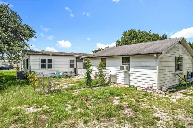 a view of a house with backyard and sitting area