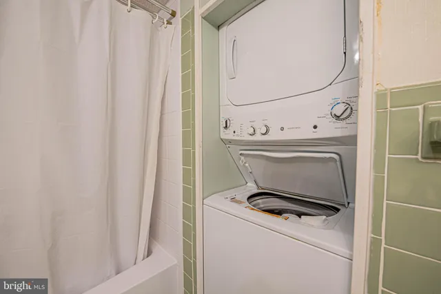 a bedroom with a bed flat screen tv and a large window