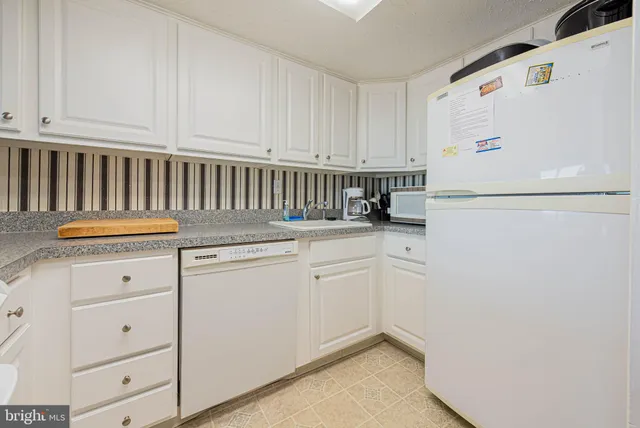 a kitchen with a stove and chairs