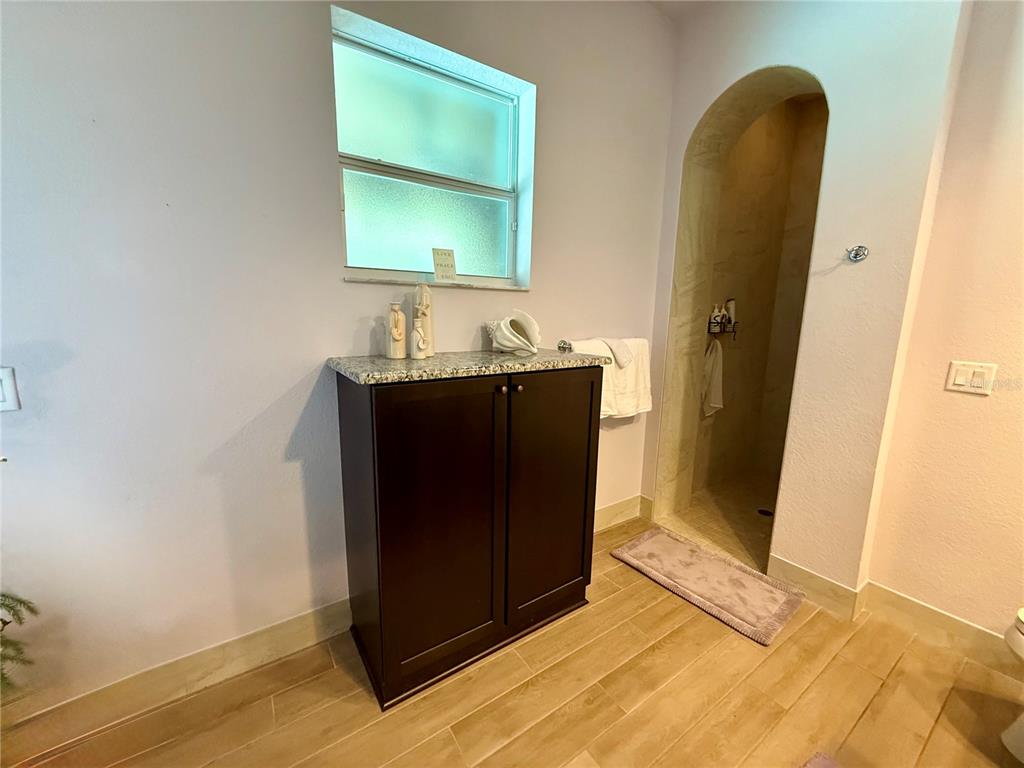 13110 Bamboo Street Spring Hill, FL 34609 - Photo 32 of 56 a room with two mirror and a wooden floor