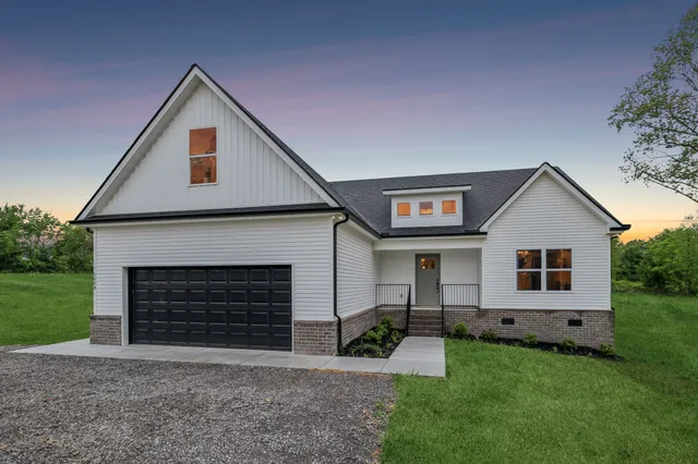 a front view of a house with a yard and garage