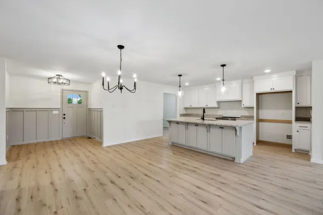 a view of a kitchen with a sink stainless steel appliances and cabinets