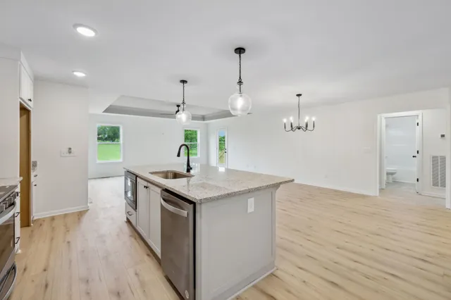 a kitchen with stainless steel appliances kitchen island a large island in the center