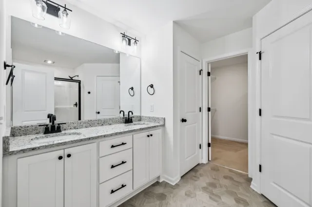a bathroom with a granite countertop sink mirror and double