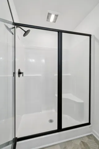 a bathroom with a glass shower door
