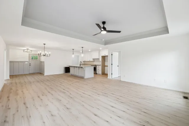 a view of empty room with wooden floor and window