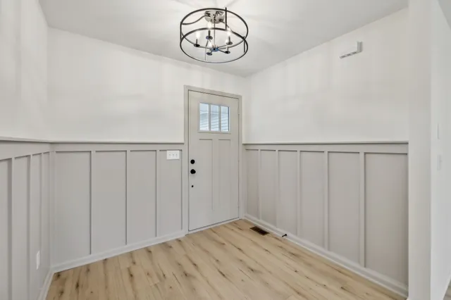 a view of an empty room with wooden floor