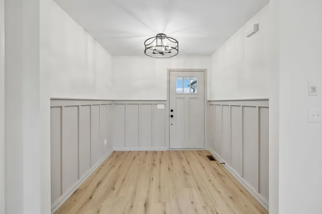 a view of empty room with wooden floor