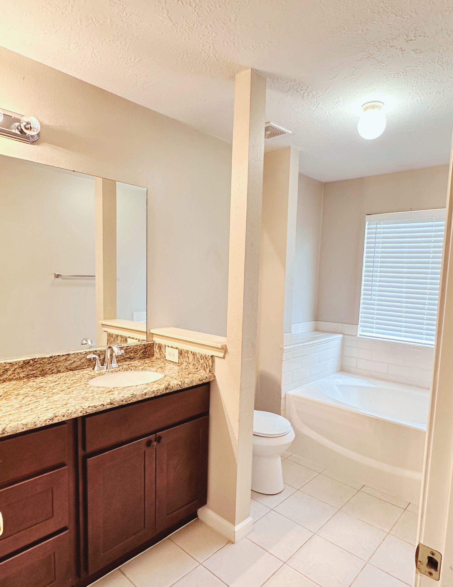 22707 Bridgewater Drive Spring, TX 77373 - Photo 7 of 11 a spacious bathroom with a granite countertop sink toilet and shower