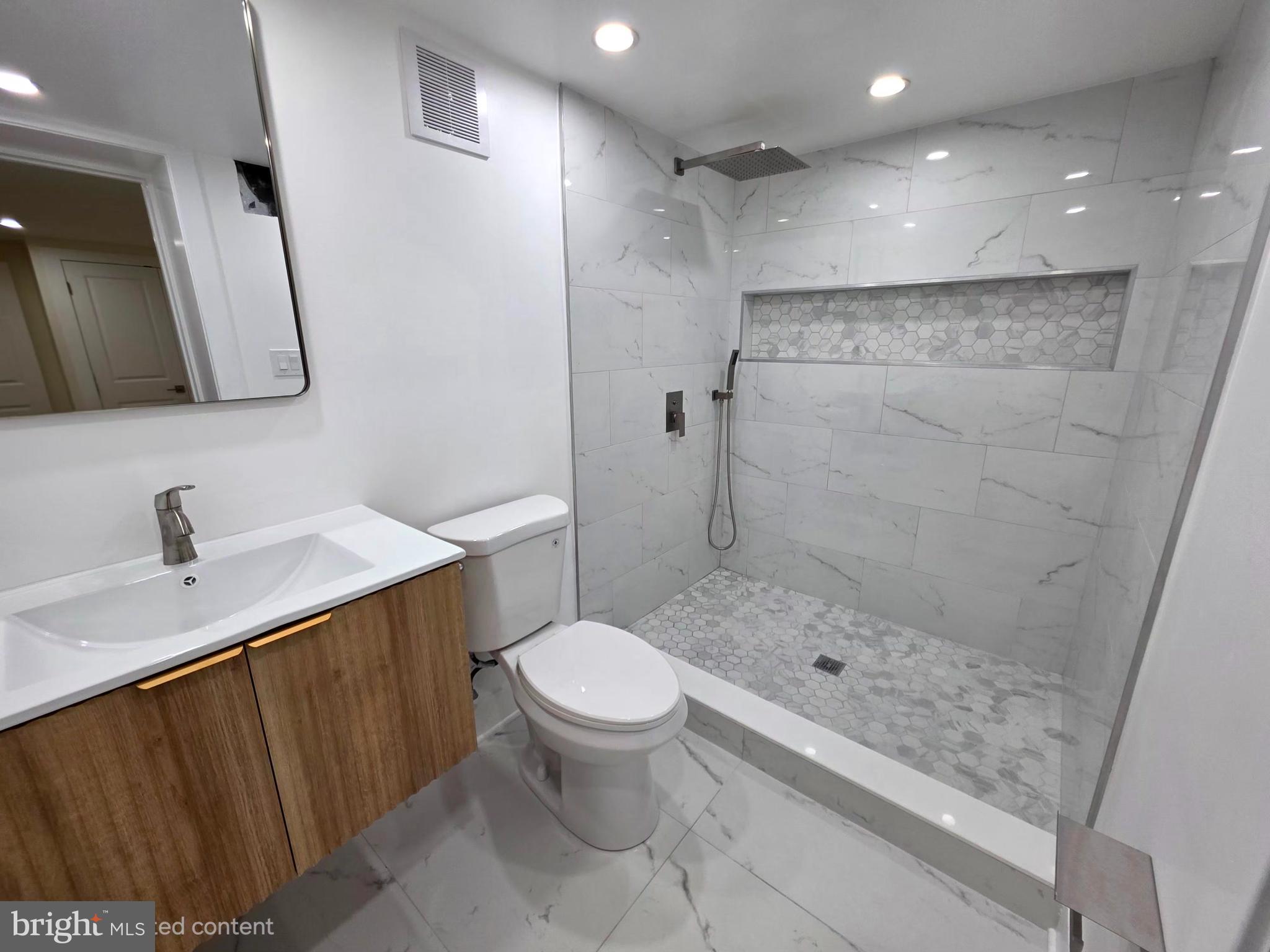 2206 Brinkley Road Fort Washington, MD 20744 - Photo 78 of 78 a bathroom with a sink a toilet and shower
