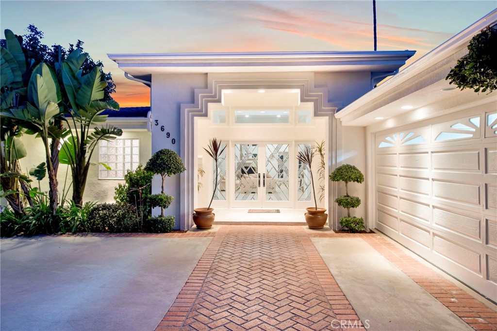 a lobby with furniture and a potted plant