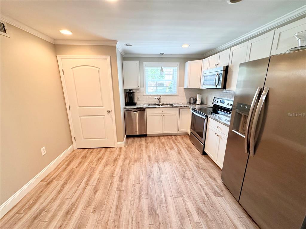 4318 Lake Underhill Road, Unit 17 Orlando, FL 32803 - Photo 12 of 12 a kitchen with a refrigerator a sink and dishwasher