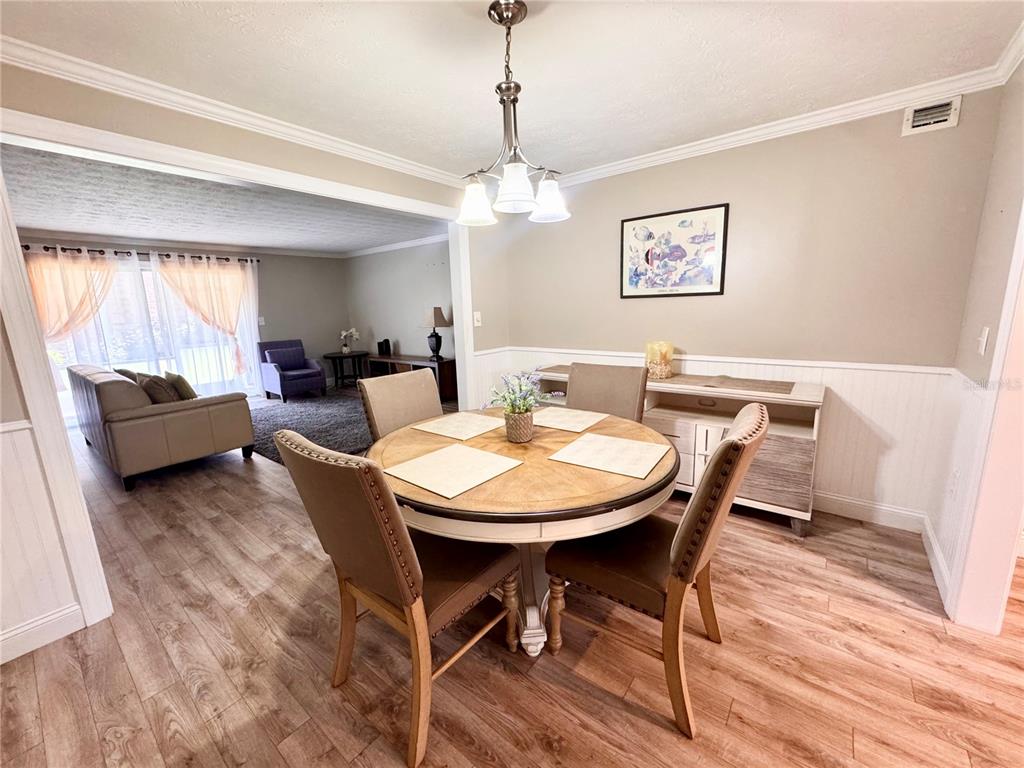 4318 Lake Underhill Road, Unit 17 Orlando, FL 32803 - Photo 2 of 12 a view of a dining room with furniture window and wooden floor