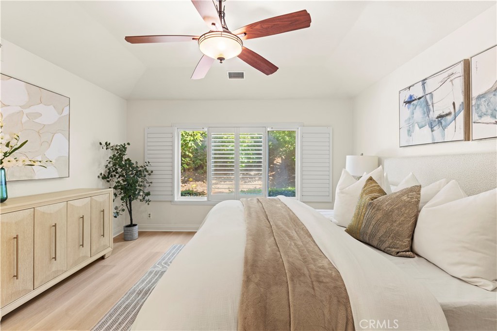 13 Grant Irvine, CA 92620 - Photo 16 of 27 a spacious bedroom with a large bed a chandelier and a window