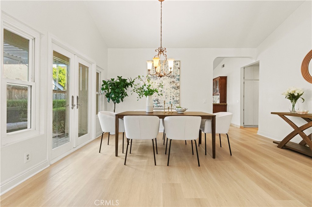 13 Grant Irvine, CA 92620 - Photo 9 of 27 a dining room with furniture a chandelier and wooden floor