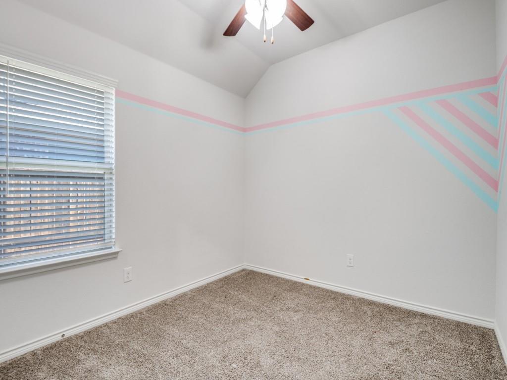 2804 Lenham Lane Forney, TX 75126 - Photo 7 of 12 an empty room with a chandelier fan