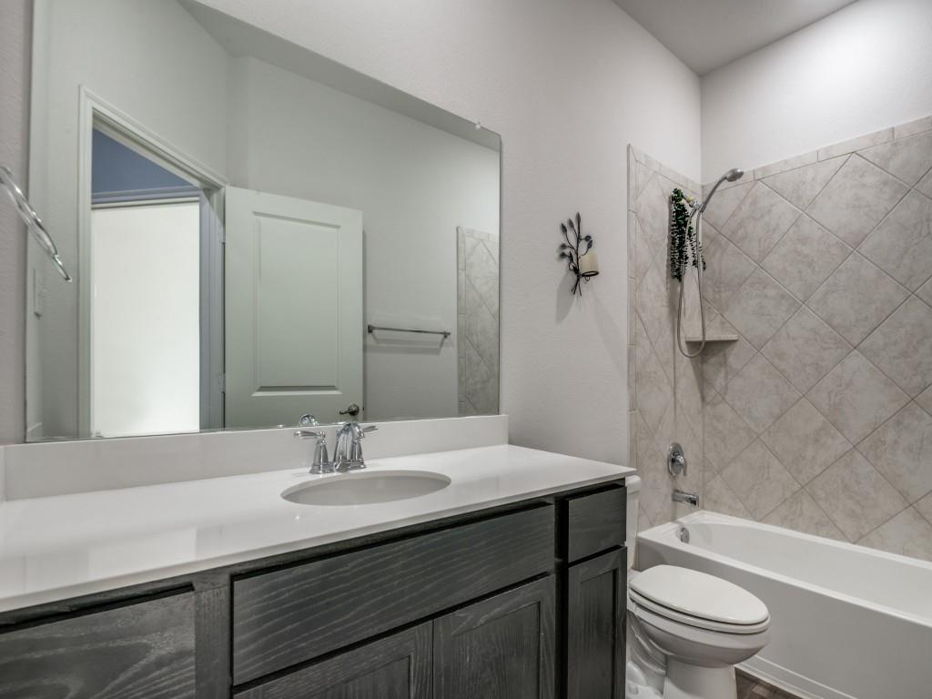 2804 Lenham Lane Forney, TX 75126 - Photo 9 of 12 a bathroom with a sink a toilet and shower
