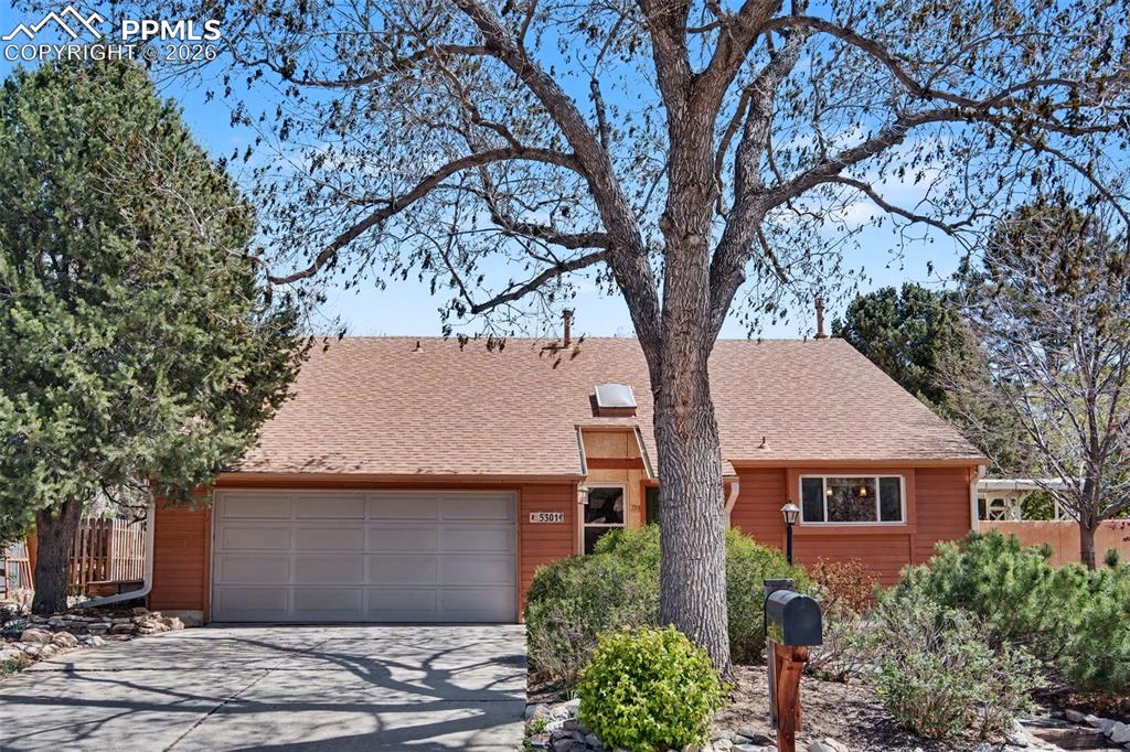 5301 Pinon Valley Road Colorado Springs, CO 80919 - Photo 2 of 27 front view of house with a trees