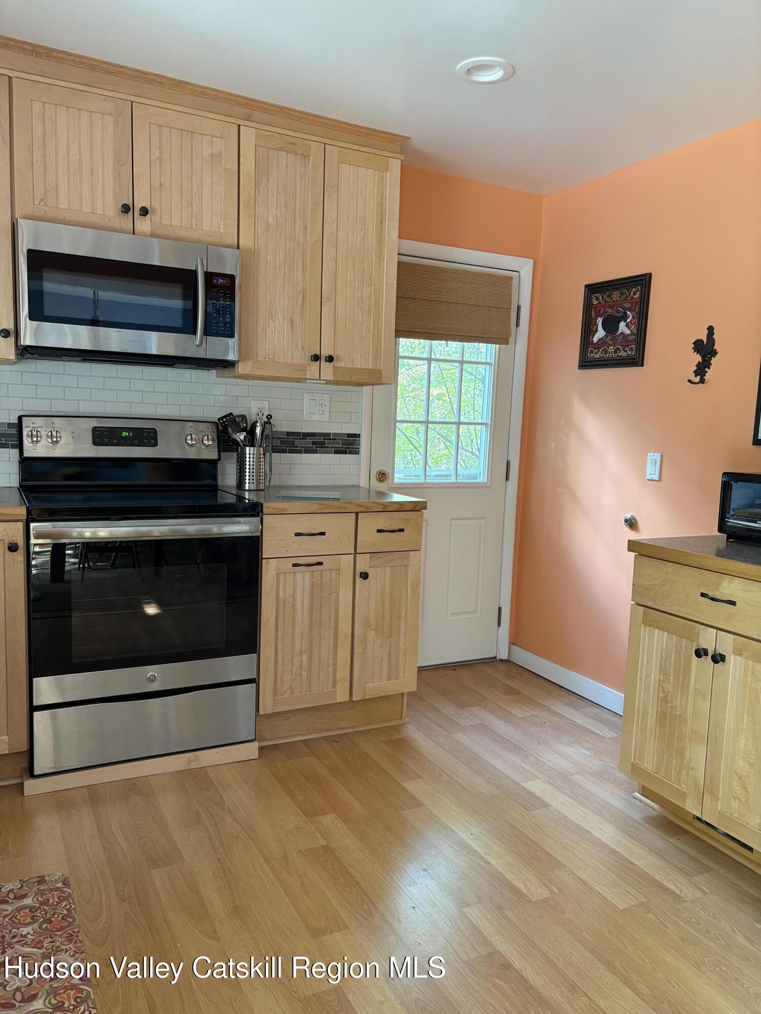 336 Ashley Hill Road Chatham, NY 12024 - Photo 11 of 27 a kitchen with stainless steel appliances granite countertop a stove a sink and a microwave