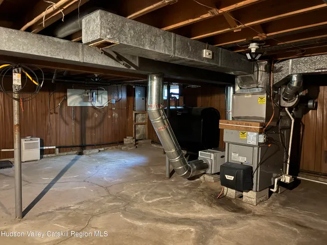 a view of water heater room with wooden floor