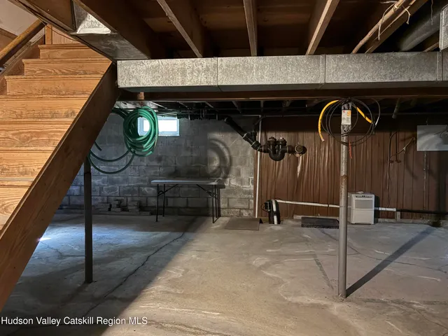 a porch with a tree in front of the house