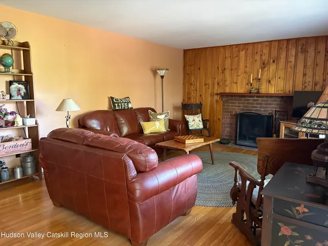 a living room with furniture a lamp and a fireplace