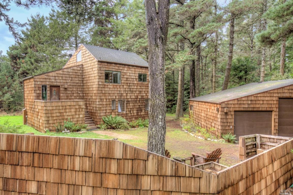 a view of house with backyard and trees