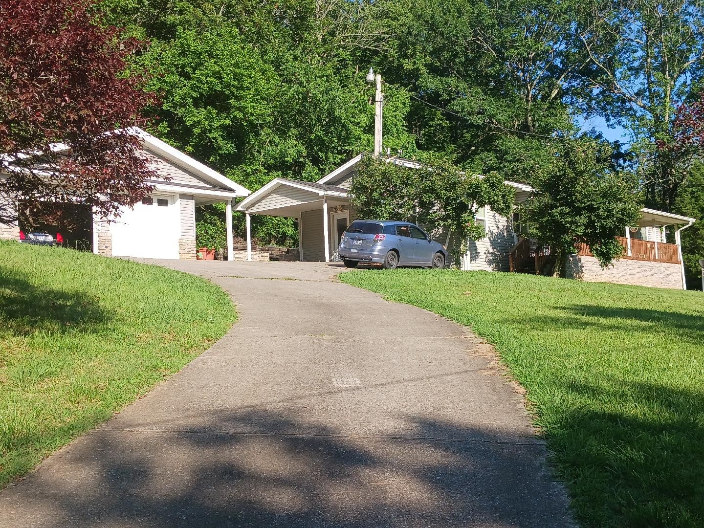 265 Harris Hollow Road Pleasant Shade, TN 37145 - Photo 1 of 15 a front view of a house with a yard and trees