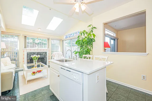 a kitchen with a sink a refrigerator a stove a dining table and chairs